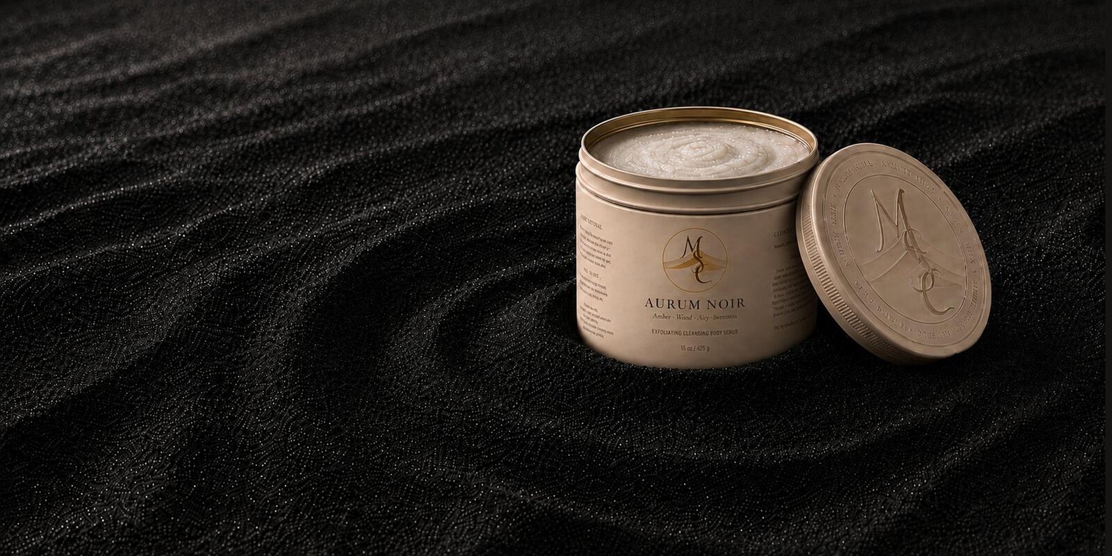 Aurum Noir exfoliating scrub in matte steel tin, lid open